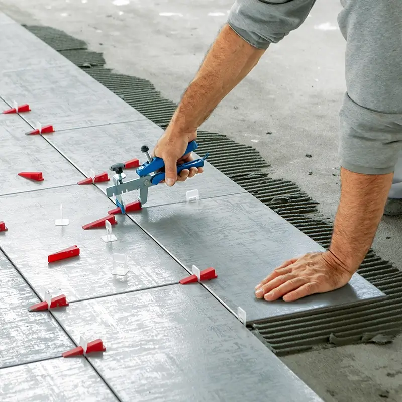 Applying Tile Adhesive and Spacers for Installation | Carpets of Dalton