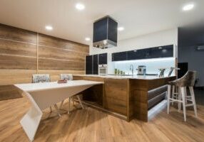 Laminate Custom Wood Floor in a living room kitchen area by Carpets of Dalton